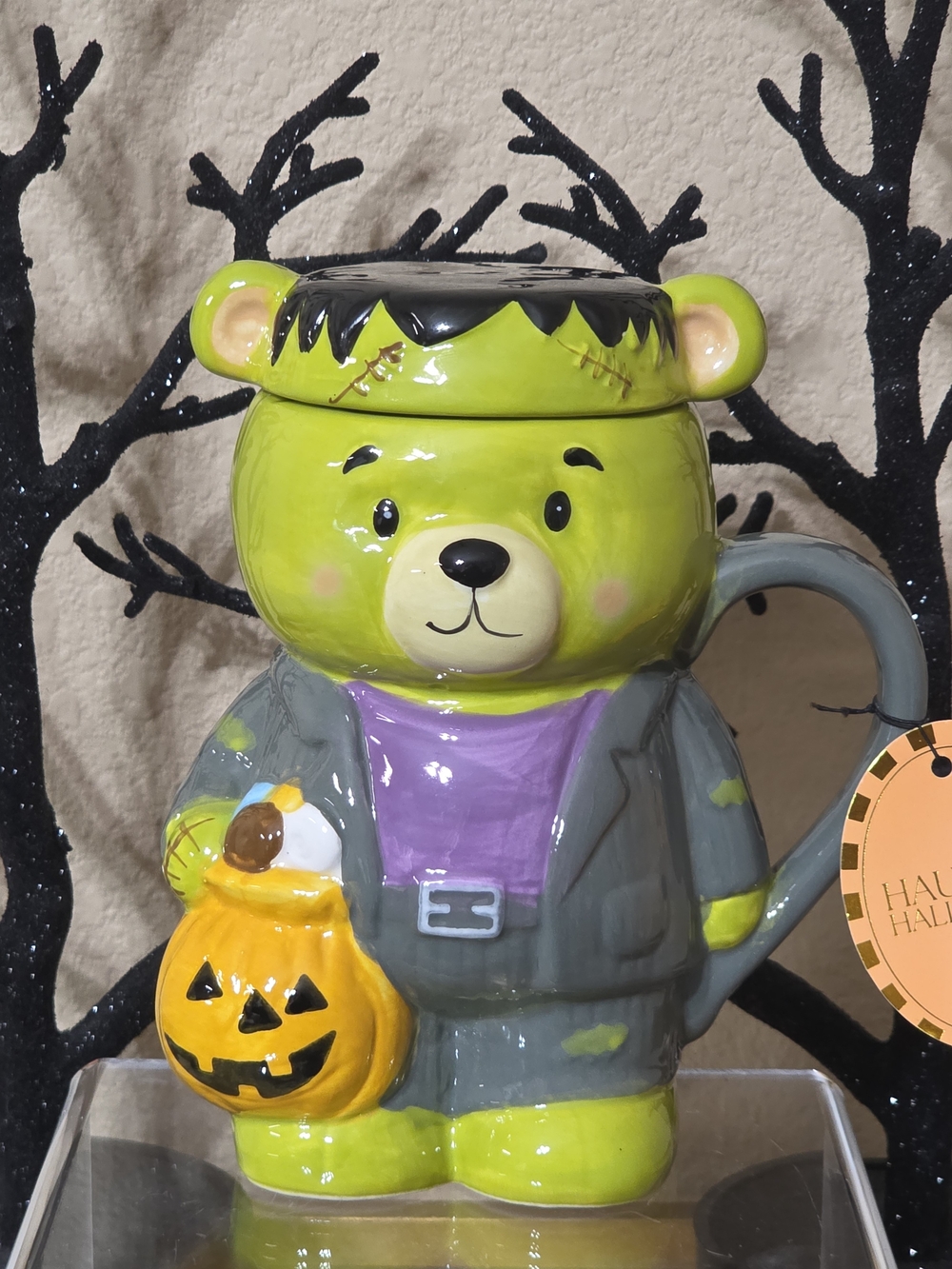 Frankenstein Bear Halloween Mug with Lid Holding A Jack-o-lantern